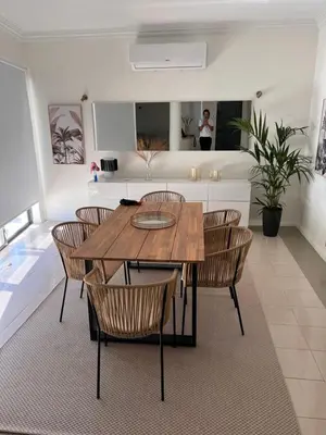 a dining room with a wooden table and chairs at Vivenda Fairways in Quarteira
