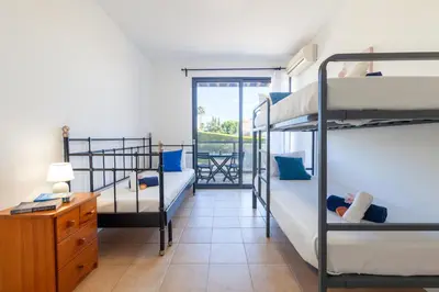 a room with two bunk beds and a desk at Townhouse Ocean Joy by Algarve Vacation in Albufeira