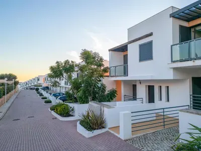 an apartment building with a row of potted plants at Townhouse Ocean Joy by Algarve Vacation in Albufeira
