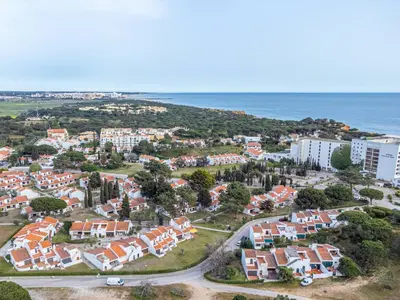 an aerial view of a residential neighborhood next to the ocean at Falésia Sunset Villa by HelloVacations in Albufeira
