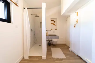 a bathroom with a shower and a sink at Falésia Sunset Villa by HelloVacations in Albufeira
