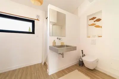 a bathroom with a sink and a toilet at Falésia Sunset Villa by HelloVacations in Albufeira