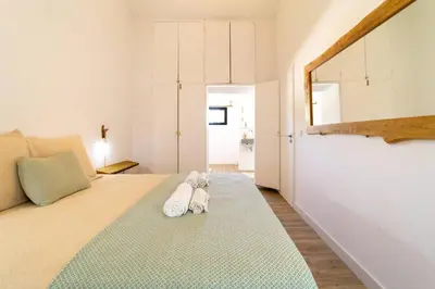 a bedroom with a bed with two towels on it at Falésia Sunset Villa by HelloVacations in Albufeira