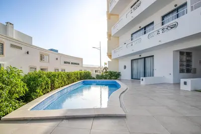 a swimming pool in the courtyard of a building at Ocean Apt 200meters Beach AC Wi-Fi Balcony in Albufeira