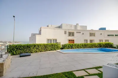 a house with a swimming pool in front of it at Ocean Apt 200meters Beach AC Wi-Fi Balcony in Albufeira