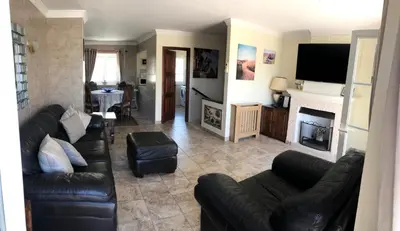 a living room with a couch and a fireplace at Old Village Vilamoura Beautiful 3 Bed townhouse in Vilamoura