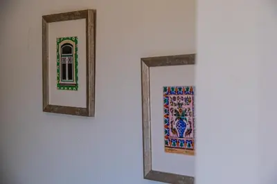 two framed mirrors on a wall with a window at Villa Laranja in Guia