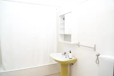 a bathroom with a yellow sink and a tub at Apartment Marisela in Albufeira