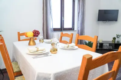 a dining room table with a white tablecloth and fruit on it at Apartment Marisela in Albufeira