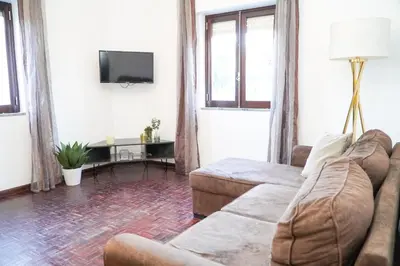 a living room with a couch and a tv at Apartment Marisela in Albufeira