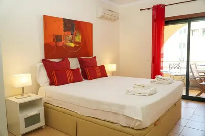a bedroom with a large bed with red pillows at Sacada Apartment in Guia