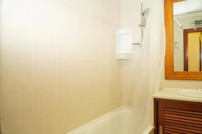 a bathroom with a bath tub and a sink at Sacada Apartment in Guia