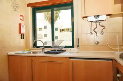 a kitchen with a sink and a window at Sacada Apartment in Guia