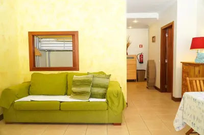 a green couch sitting in a living room at Sacada Apartment in Guia