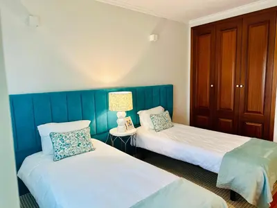 a room with two beds and a lamp on a table at Appartement Talia in Albufeira