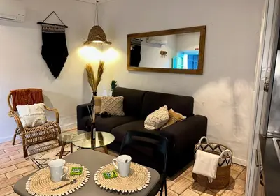 a living room with a couch and a table at Casa Da Alegria in Albufeira