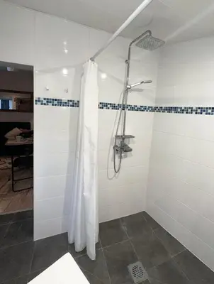 a shower with a shower curtain in a bathroom at Casa Da Alegria in Albufeira