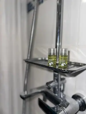two glasses of oil on a shelf in a bathroom at Casa Da Alegria in Albufeira