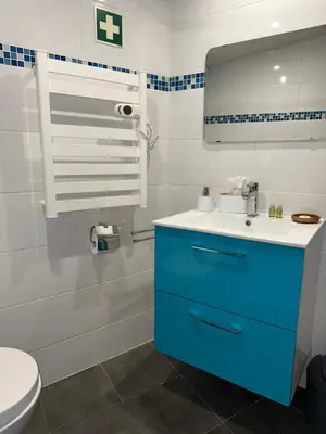 a bathroom with a blue cabinet and a sink at Casa Da Alegria in Albufeira