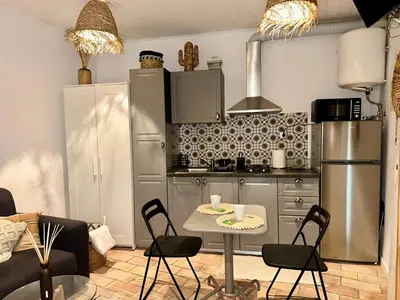 a kitchen with a table and chairs in a room at Casa Da Alegria in Albufeira