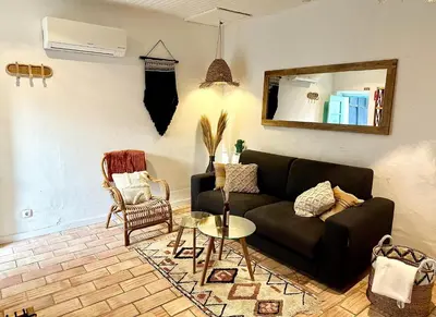 a living room with a couch and a table at Casa Da Alegria in Albufeira