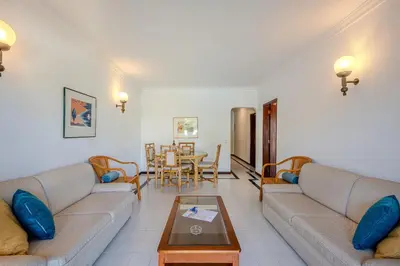 a living room with two couches and a table at Casa Rita by Sunnyway in Olhos de Água