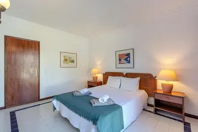 a bedroom with a bed with two towels on it at Casa Rita by Sunnyway in Olhos de Água