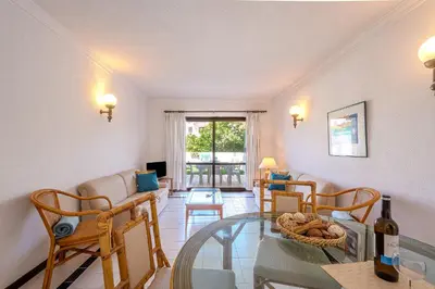 a living room with a glass table and chairs at Casa Rita by Sunnyway in Olhos de Água