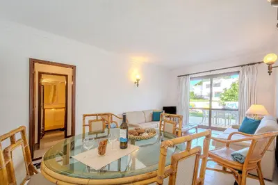 a living room with a glass table and chairs at Casa Rita by Sunnyway in Olhos de Água