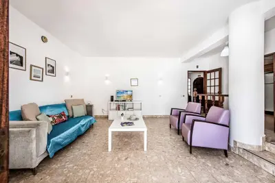 a living room with a blue couch and a table at Villa Serenity in Albufeira