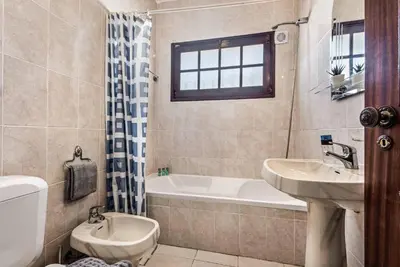 a bathroom with a sink and a toilet and a bath tub at Villa Serenity in Albufeira