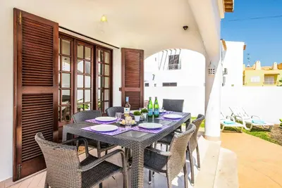 a villa with a swimming pool and lounge chairs at Villa Serenity in Albufeira