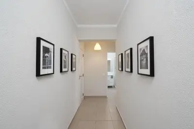 a hallway with a bunch of pictures on the walls at ISA - Quarteira in Quarteira