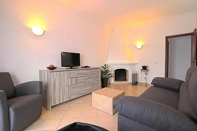 a living room with a tv and a fireplace at Dinita Apartamentos in Albufeira