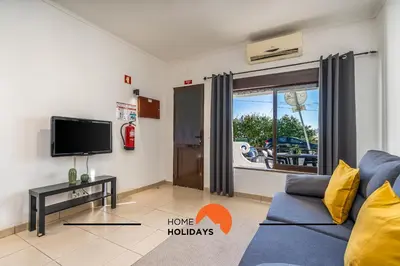 a kitchen and living room with a table and chairs at #253 Fernando Pessoa 28 by Home Holidays in Albufeira