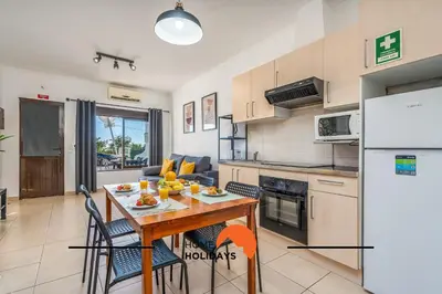 a living room with a couch and a window at #253 Fernando Pessoa 28 by Home Holidays in Albufeira