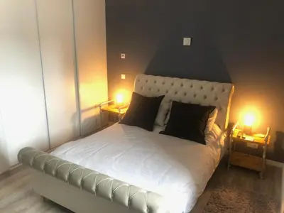 a bedroom with a large bed with two lamps on it at Ville Verde in Loulé