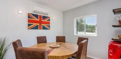 a dining room with a wooden table and chairs at Ville Verde in Loulé
