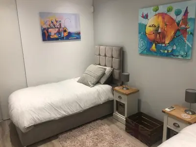 a bedroom with a bed and a painting on the wall at Ville Verde in Loulé