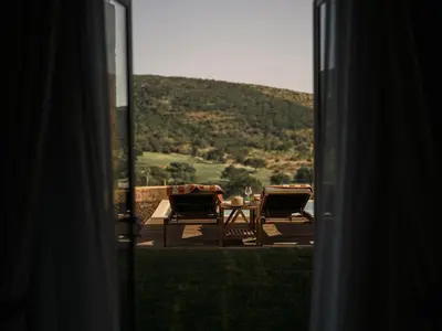 a view of a table and chairs from a window at Viceroy Residences at Ombria Algarve in Loulé