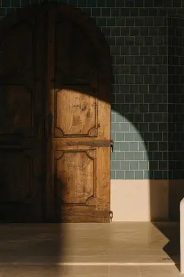 a pair of wooden doors in a brick wall at Viceroy Residences at Ombria Algarve in Loulé