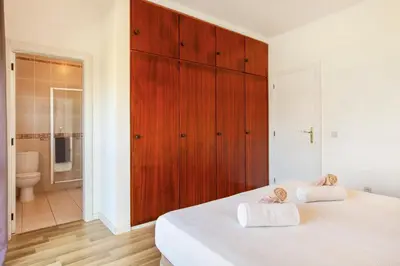 a bedroom with a white bed with two towels at Villa Bellegarde by Algarve Vacation in Albufeira
