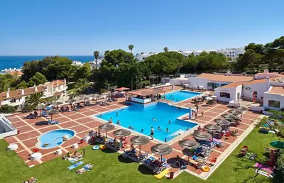 an overhead view of a swimming pool with people sitting around it at SeaView apartment by MOJE Holiday in Albufeira