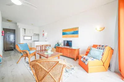 a living room with two chairs and a table at SeaView apartment by MOJE Holiday in Albufeira