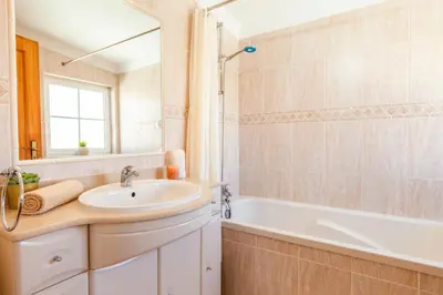 a bathroom with a sink and a tub at Villa Sunny Joy by Algarve Vacation in Albufeira