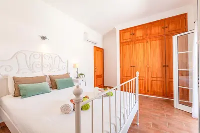 a bedroom with a white bed and a staircase at Villa Sunny Joy by Algarve Vacation in Albufeira