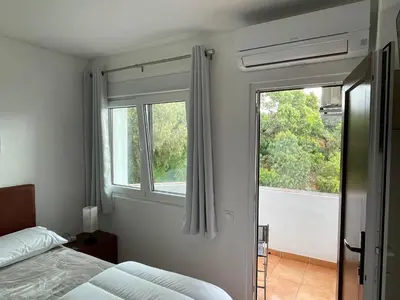 a bedroom with a bed and a window at OuraSea Apartment in Albufeira