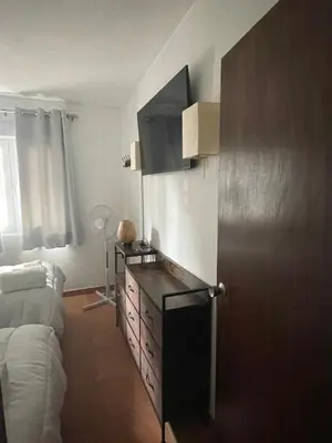 a living room with a dresser and a couch at OuraSea Apartment in Albufeira