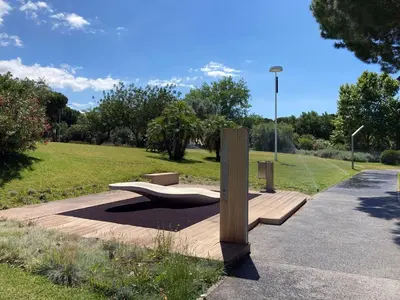 a park with a bench on the side of a road at Barca do Lago - Vilamoura in Vilamoura