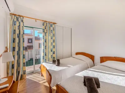 two beds sitting next to each other in a room at Holiday Home V3 Aguia M - VIP Properties by Interhome in Albufeira